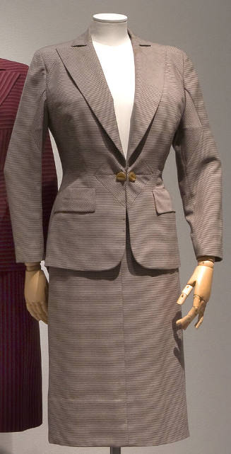 Brown and fine white striped suit with side by side button front closure surrounded by triangul…