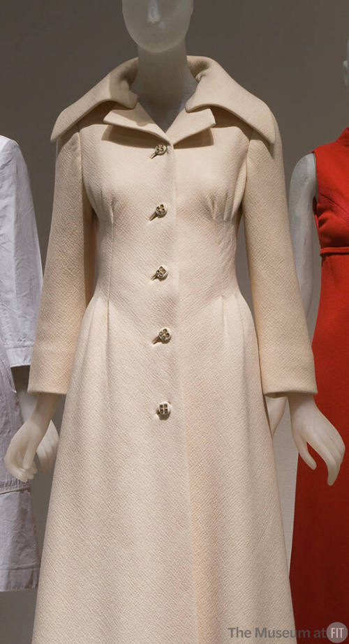 Cream evening coat with stylized peaked lapels and oversize shawl collar, princess seaming at b…