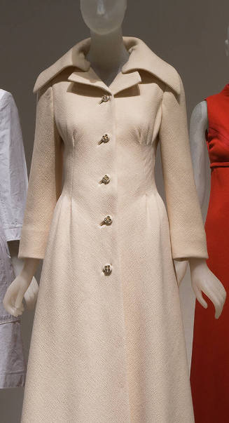 Cream evening coat with stylized peaked lapels and oversize shawl collar, princess seaming at b…
