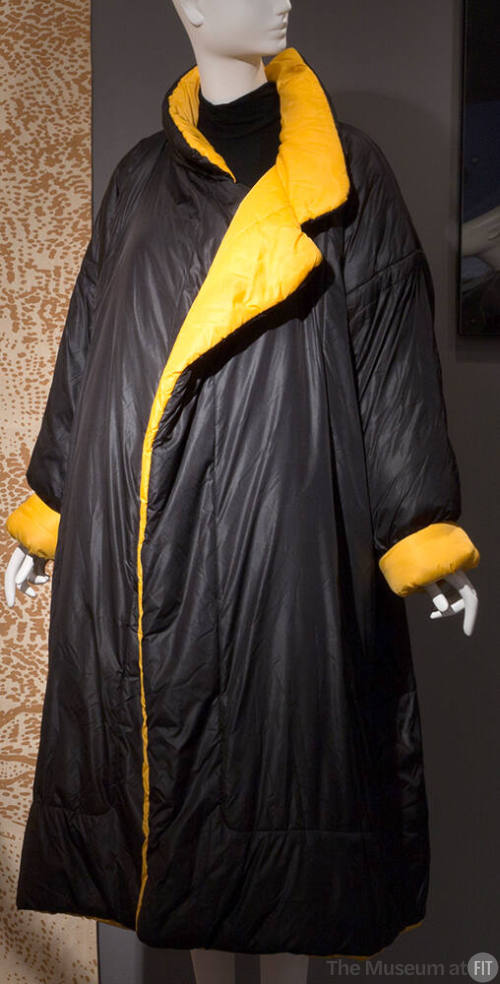 Black padded ankle length sleeping bag coat with stand collar, notched lapels and turn back cuf…