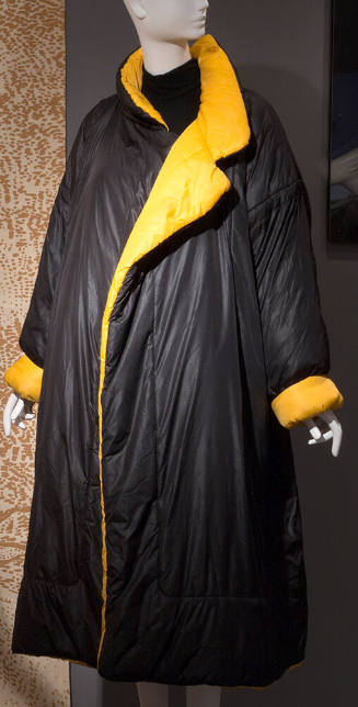 Black padded ankle length sleeping bag coat with stand collar, notched lapels and turn back cuf…