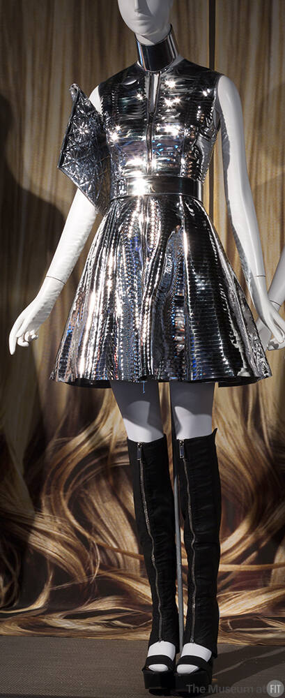 Silver metallic sleeveless dress with above the knee flared skirt, matching choker, belt and bl…