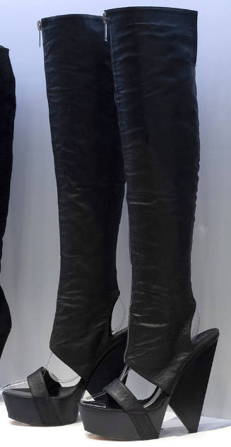 Pair of black thigh high platform wedge boots with sandal style single strap across open vamp, …