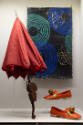 Fashioning Wonder exhibition installation view of “The Senses” case with an umbrella, a pair of…