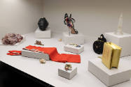 Fashioning Wonder exhibition installation view of the “Vanitas” case with bags, a hat, jewelry,…