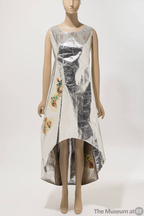 Silver sleeveless dress with high low hem from knees to ankle and multicolor floral appliques t…