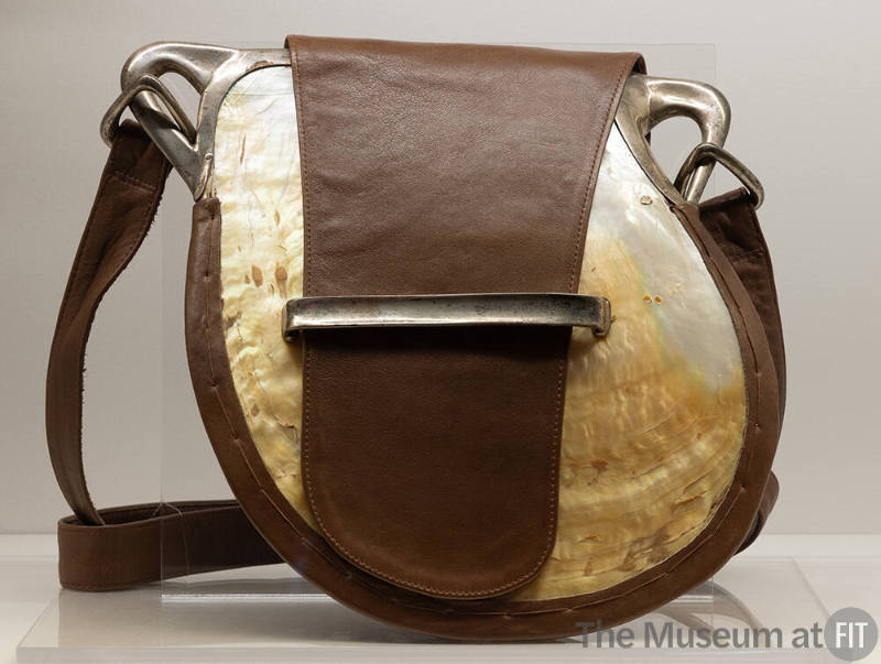 Shoulder bag made from a large iridescent shell with brown leather trim, strap and tab closure …