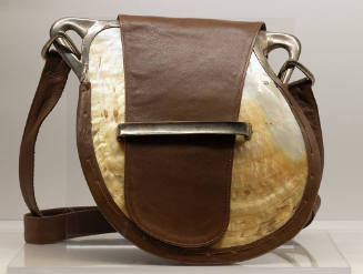Shoulder bag made from a large iridescent shell with brown leather trim, strap and tab closure …