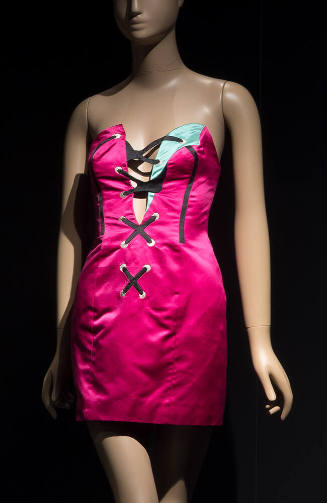 Fuchsia strapless mini dress with aqua accent at bust and black lacing appliques down deep V-ne…