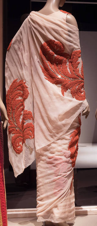 Rear view of light pink sari with large red embroidered feather plumes accented with silver seq…