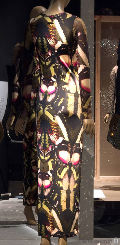 Long sleeve floor length fitted dress with repeating green, pink and black moth print