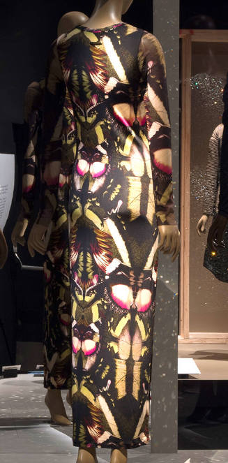 Long sleeve floor length fitted dress with repeating green, pink and black moth print