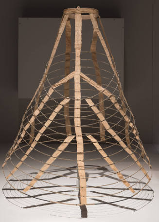 Cage underskirt of concentric wire circles connected by beige cotton tape shown fully extended
