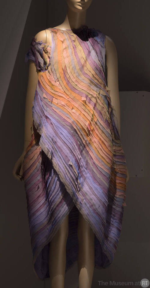 Evening dress made of layered strips in various shades of purple, yellow, orange and brown, one…