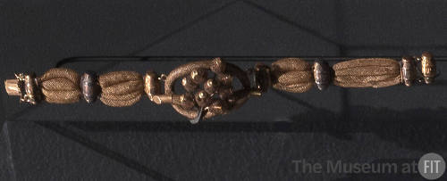 Bracelet of woven hair with gold barrel fittings spaced throughout and large central knot with …
