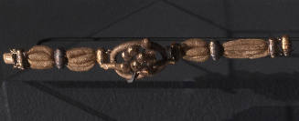 Bracelet of woven hair with gold barrel fittings spaced throughout and large central knot with …