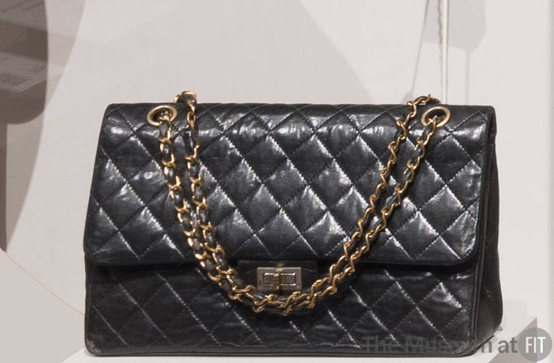Black quilted leather envelope handbag with swivel clasp closing on front flap and gold chain s…