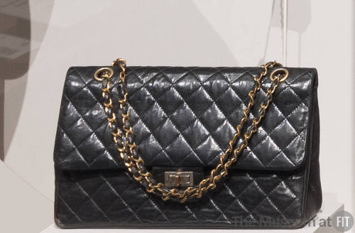 Black quilted leather envelope handbag with swivel clasp closing on front flap and gold chain s…