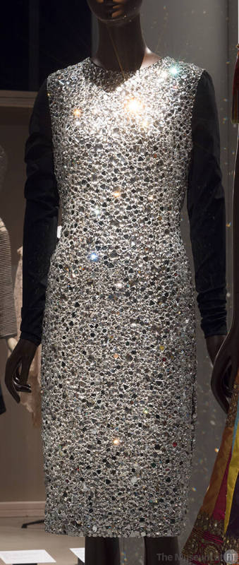 Cocktail dress of mirrored glass stones with long black sleeves 