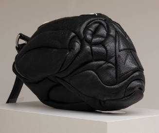 Black leather bag in the shape of an elongated skull with quilting throughout to create skull f…