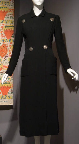 Black fitted double breasted coat with four large silver buttons and two patch pockets on hips