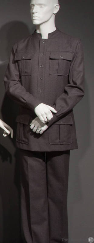 Man’s grey safari style suit with stand collar, button front jacket and four button flap patch …
