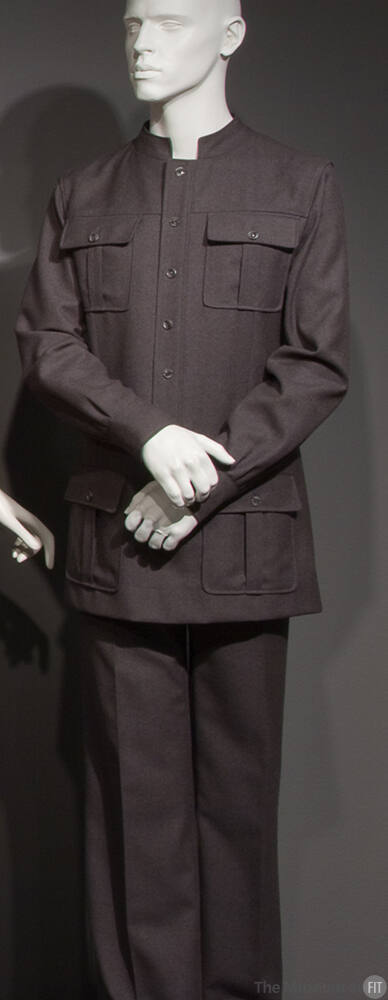 Man’s grey safari style suit with stand collar, button front jacket and four button flap patch …