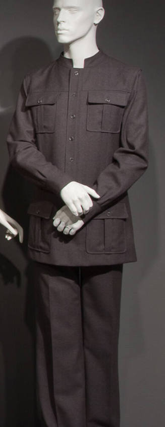 Man’s grey safari style suit with stand collar, button front jacket and four button flap patch …