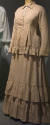 Tan two-piece floor length dress with oval green dot pattern, button front long sleeve bodice w…