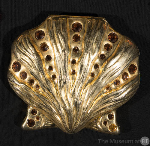 Gold metal clam shell minaudiere evening bag with brushwork effects of various gold tones and r…