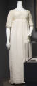 White cotton gauze floor length dress with empire waist, elbow length sleeves and embroidery th…