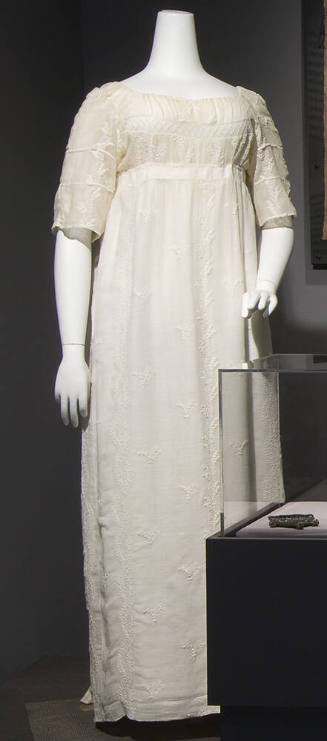White cotton gauze floor length dress with empire waist, elbow length sleeves and embroidery th…