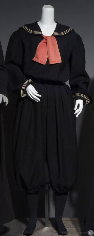 Black sailor style gym suit with white trim on sailor collar and cuffs, large red neck tie, fit…