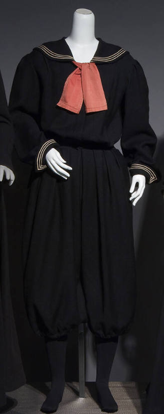 Black sailor style gym suit with white trim on sailor collar and cuffs, large red neck tie, fit…