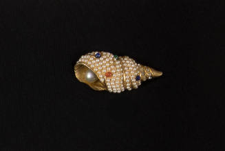 Gold brooch in the shape of a tulip shell covered in seed pearls, rhinestones, and blue, green …