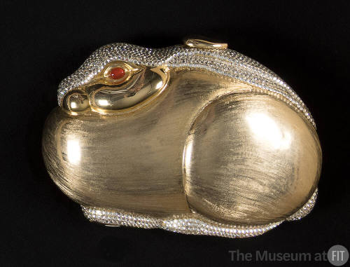 Gold metal miniature evening bag in the shape of a rabbit with rhinestone pavé at top and base …