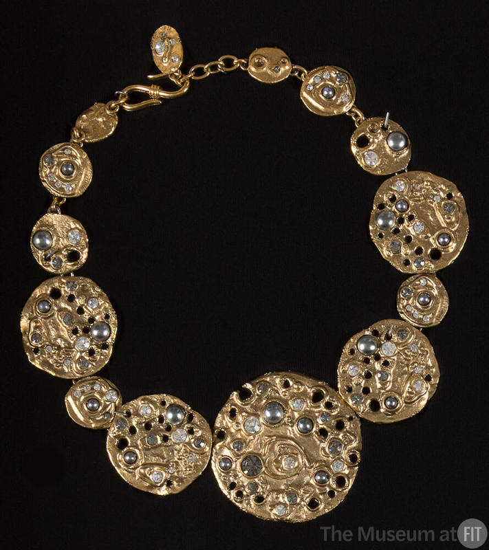 Necklace of molten gold discs of graduating size encrusted with rhinestones, iridescent stones …