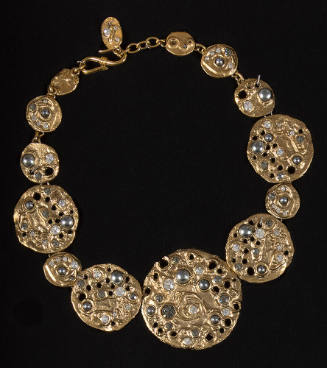 Necklace of molten gold discs of graduating size encrusted with rhinestones, iridescent stones …