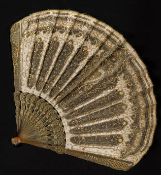 Gold metallic fan with floral design on amber frame and silk net and cream cut-out work embroid…