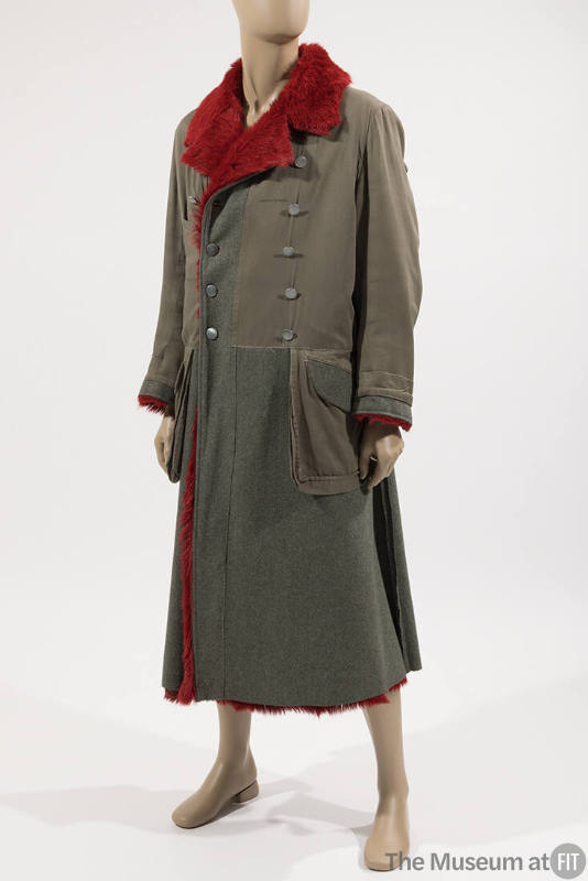 Man’s green military style coat with notched collar lined in red fur, double breasted with silv…