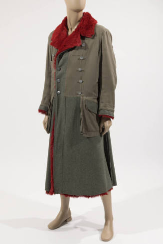 Man’s green military style coat with notched collar lined in red fur, double breasted with silv…