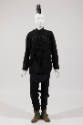 Man’s ensemble of a black long sleeve shirt with multiple straps across front and on matching s…