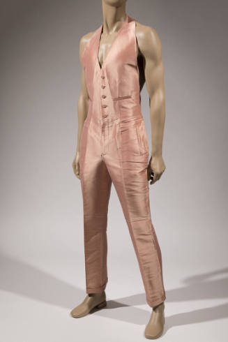 Man’s pink silk halter neck jumpsuit with waistcoat style top with five button closure, side po…