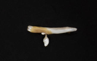 Mother of pearl pin in the shape of a branch with baroque pearl dangling left of center