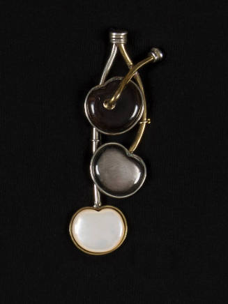 Pin in the shape of three cherries in black, grey and white stones with brass and silver stems