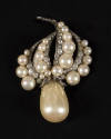 Large baroque pearl teardrop brooch with pearl and rhinestone arms at top resembling flames or …