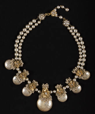 Two strand pearl chocker necklace with six medallions flanking one large central teardrop shape…