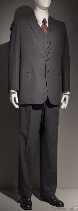 Man’s dark grey three-piece suit with single breasted jacket, vest and straight leg pants dress…