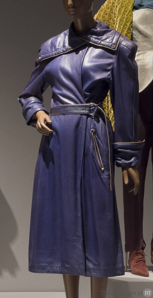 Purple leather trench coat with gold piping, wide asymmetrical shawl collar, off-center closure…