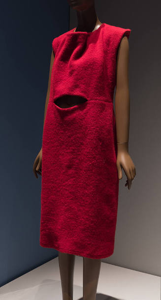 Red sleeveless below-the-knee shift dress with oblong cut out at center waist
